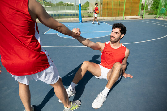Two friends on a basketball court showing sportsmanship and teamwork