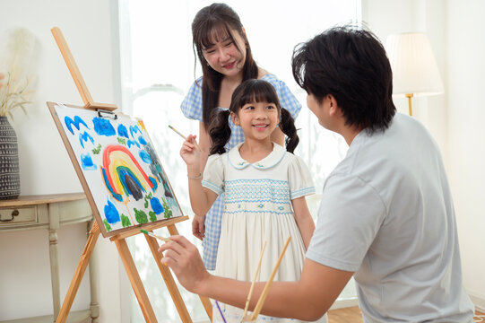 Girl Paints With Family in Home as They Enjoy Creative Education Time Together