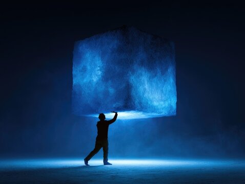 Person Reaching Out to Enormous Glowing Ice Cube in Dark Environment