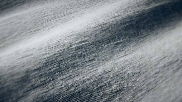 Widescreen loop of light gray heathered knit fabric with fine ribbed texture and soft folds, premium loungewear and minimalist interior texture background