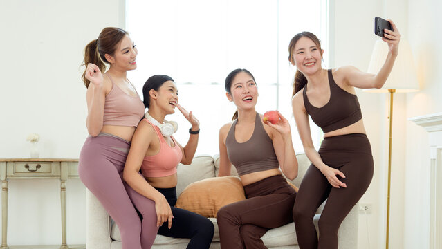 Friends Taking a Selfie Together in a Bright Living Room During a Workout Session