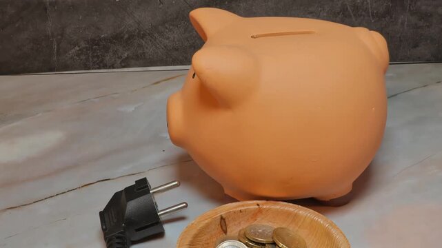 piggy bank power cord coins savings household electricity cost