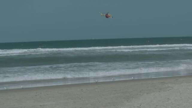 Westpac Lifesaver Rescue Helicopter Flying Over Waves at Sunshine