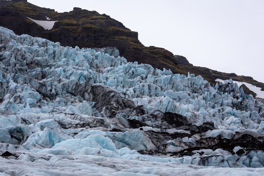 Skaftafell Glacier icefall and mountain slopes in Iceland