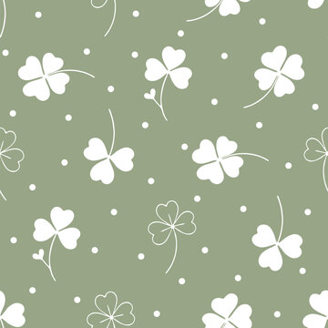 Cute four leaf clover seamless pattern with white polka dots on minimalist sage green background. Lucky clover, botanical leaves, and little dots hand drawn vector illustration.