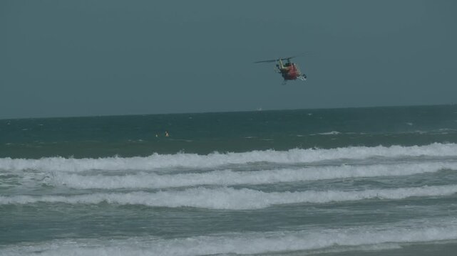 Westpac Lifesaver Rescue Helicopter Flying Above Beach Waves in Slow