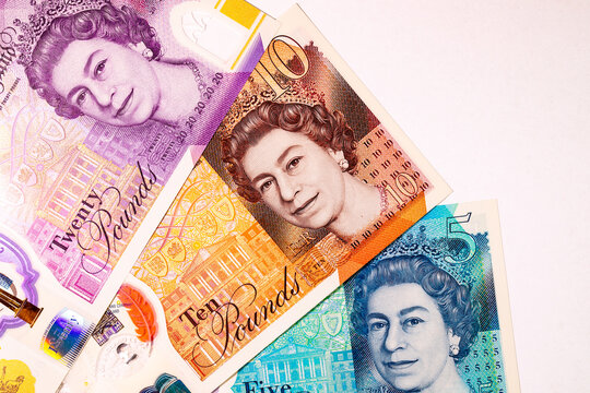 British currency, featuring various Great Britain Pound (GBP) banknotes including 5, 10, and 20 pound notes with Queen Elizabeth II portrait. Money of Europe.