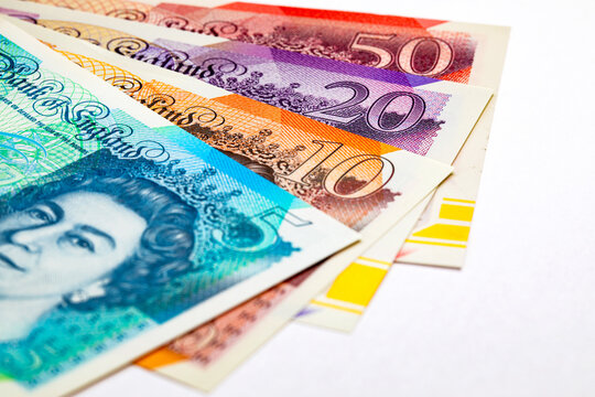 British currency, featuring various Great Britain Pound (GBP) banknotes including 5, 10, 20 and 50 pound notes with Queen Elizabeth II portrait. Money of Europe.