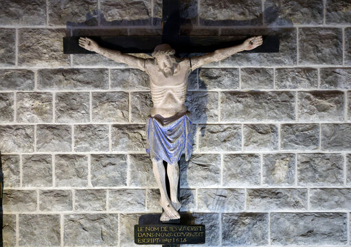 Polychrome statue of Jesus Christ crucified on a wooden cross, dated 1614.