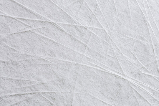 Close up texture background of white fiberglass strand mat surface