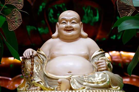 Xa Loi Pagoda. A statuette of Budai&mdash;with his beaming smile, protruding belly, and rosary&mdash;characterizes this legendary figure identified with the future Maitreya. Ho Chi Minh City, Vietnam.