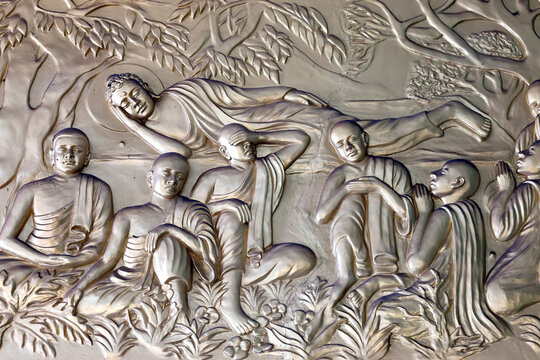 Xa Loi Pagoda. This bas-relief depicts Buddha Siddhartha Gautama in the parinirvana posture, surrounded by his disciples in prayer and meditation. Ho Chi Minh City, Vietnam.