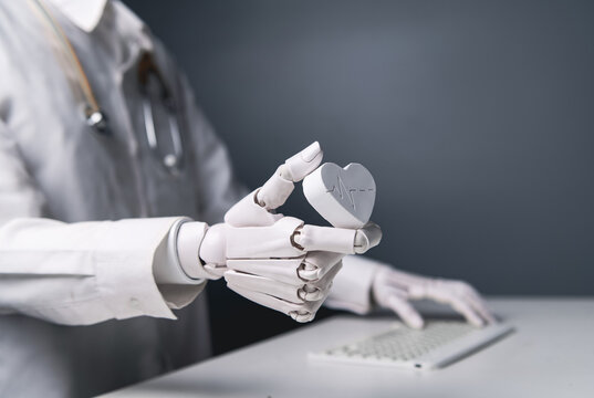 Close-up Robot Doctor Hand Holding White Heart Model for AI Cardiology Concept