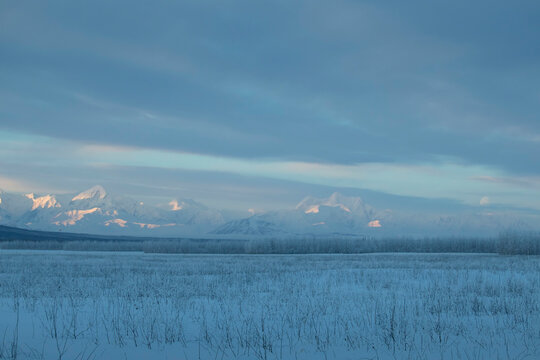 Moon over snowy mountains in Alaska