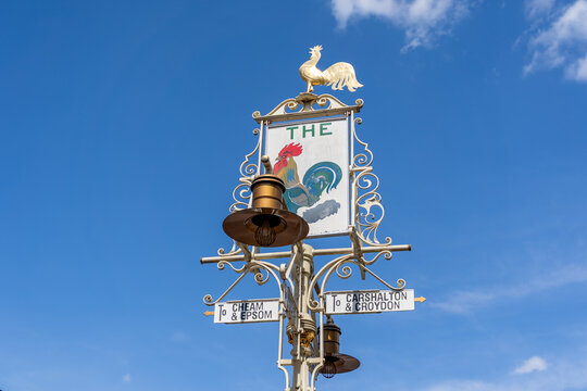 Vintage Roadsign With Rooster Emblem Pointing to Chessam Epsom Chislehurst And Croydon Under Blue Sky