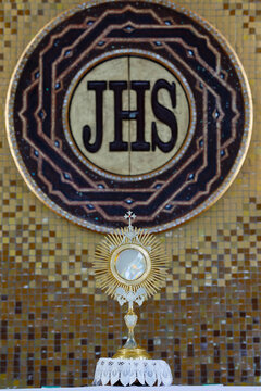 Gilded Monstrance Before IHS Symbol Altar