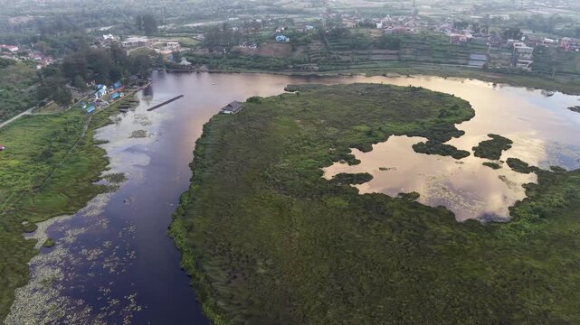 Aerial Drone View of Danau Mas Lake Surrounded by Tropical Forest in Indonesia, 4K