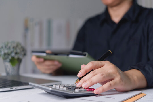 hands using calculator desk accounting finance calculating budget taxes business working financial documents pen holding folder planning investment auditing paperwork money cost bookkeeping economy