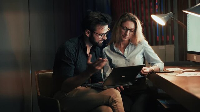 Businessmen Working On Laptop Late Night In Office. Discussion  Project And Corporate Collaboration. Teamwork 