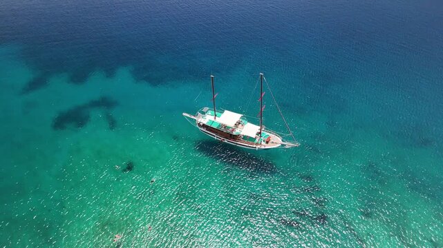 Traditional Turkish gulet anchored in crystal clear turquoise bay near Bodrum Turkey