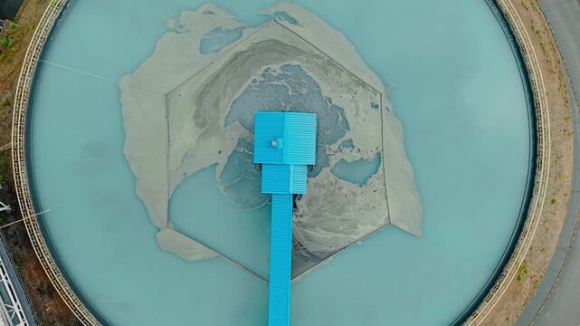 Aerial top view Industrial filtration water and treatment facility with sedimentation tanks pulp in gold, copper mining industry, manufacturing infrastructure of concentrate factory.