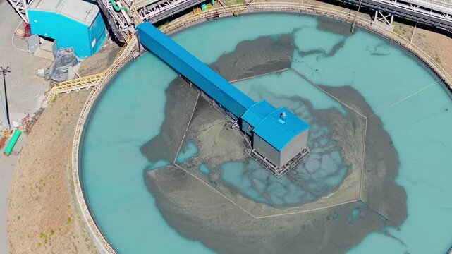 Aerial view manufacturing infrastructure of concentrate factory. Industrial filtration water and treatment facility with sedimentation tanks pulp in gold, copper mining industry.