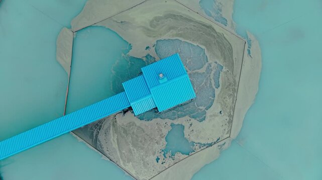 Aerial top view Industrial water treatment facility with sedimentation tanks pulp in copper mining factory.