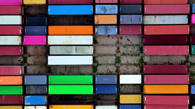 Top View of Moving Blue Crane Over Colorful Shipping Containers