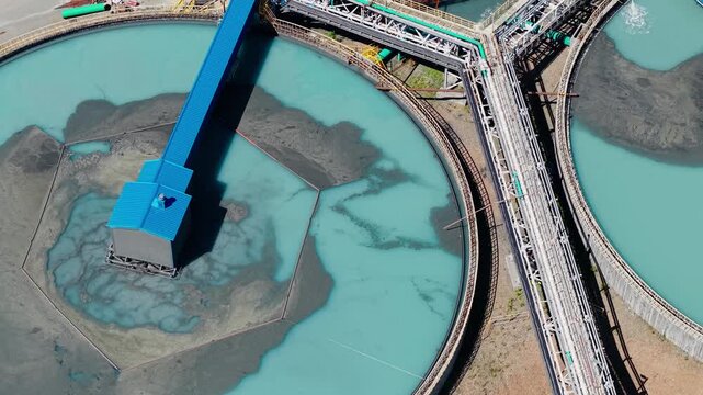 Aerial view Industrial filtration water and treatment facility with sedimentation tanks pulp in gold, copper mining industry. Manufacturing infrastructure of concentrate factory.