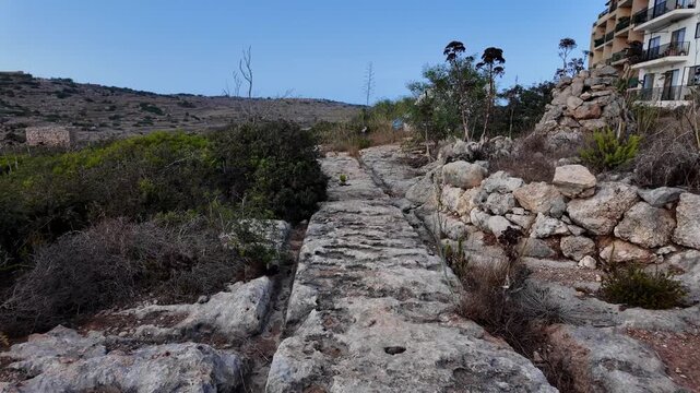 Ancient Cart Ruts on Xemxija heritage trail, parallel cartways groves cut into bare rock.