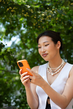 Close up of an Asian Woman Using a Mobile Phone