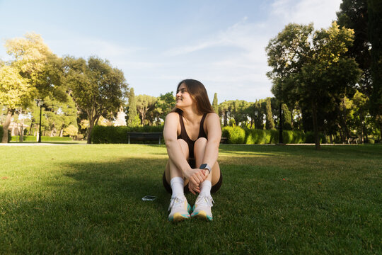 Woman enjoys a break in the park during a workout session