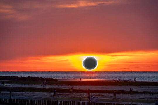 Langrune-Sur-Mer, France - 07 31 2026: A solar eclipse over the sea low on the horizon