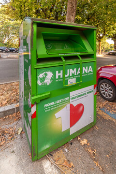 Cuneo, Italy - July 27, 2026: Green Humana clothes donation binon an Italian street. Textile recycling container for used clothing, shoes, ecological sustainability, and humanitarian charity 