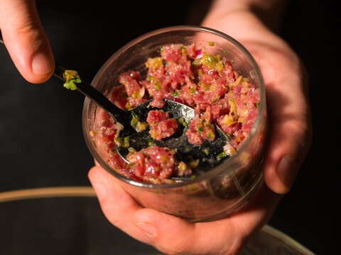 Chef making steak tartare at kitchen 