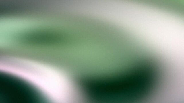 Soft green gradient background with grainy texture and smooth light wave