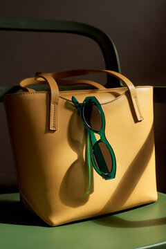 Yellow bag with green sunglasses