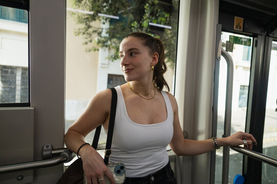 Young woman riding a public bus in Rome