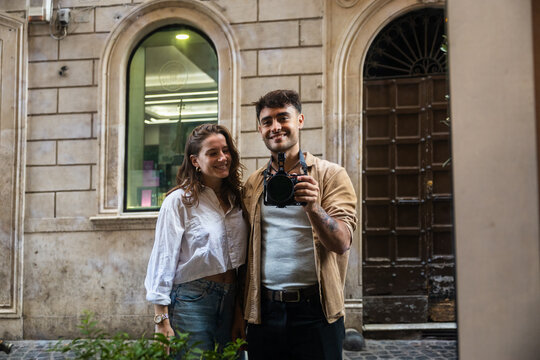 Young couple taking a mirror selfie in Rome
