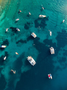 Yachts anchored in the clear adriatic sea, top down drone shots