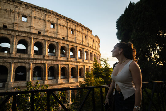 Golden hour magic: young woman face to face with the Colosseum