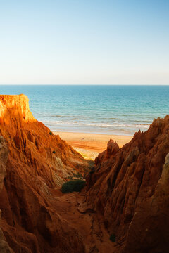 View of Cliffs Leading to Sandy Beach During Sunset.  Portugal 