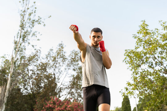 Boxer Practices Punches Outdoors in Daytime