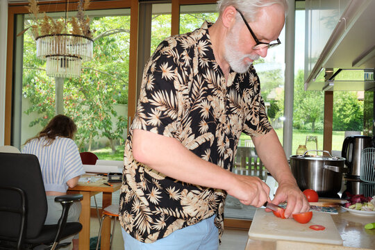 Cutting Tomatoes while Working in the Background