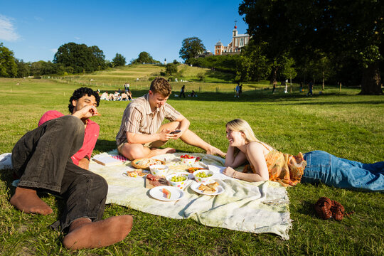 Friends having a picnic at Greenwich Park