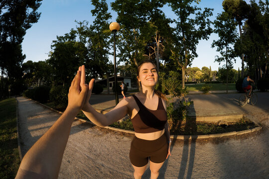 Woman enjoys running in a park under a clear blue sky during the day