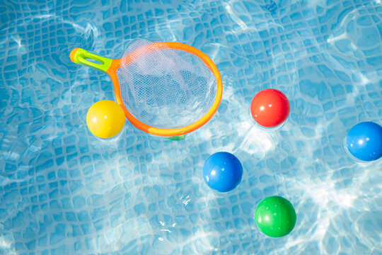 Colorful Pool Toy Net and Floating Balls in Swimming Pool
