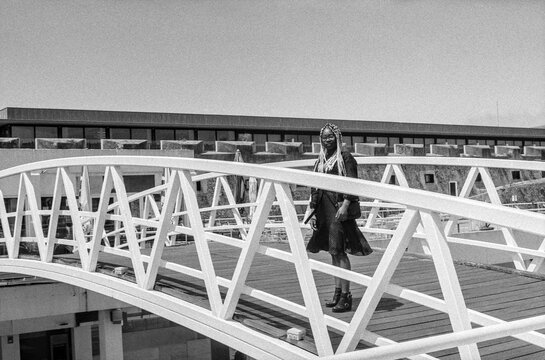 Woman Behind Bridge Rails