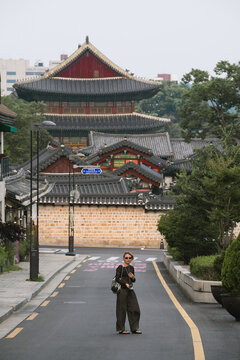 Woman Tourist Exploring Historic Changdeokgung Palace Street in Seoul