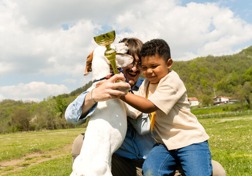 Young boy and family dog celebrate winning at a dog competition